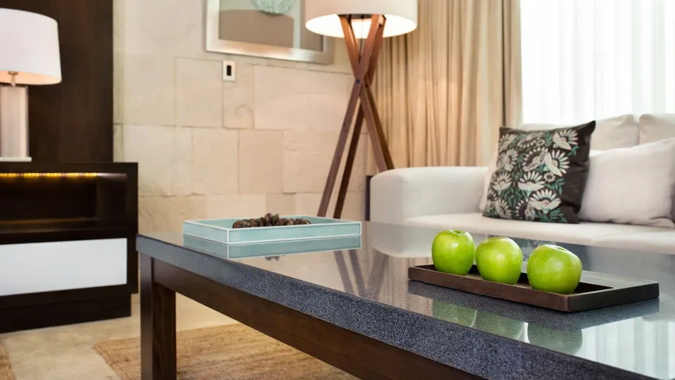 Close-up of coffee table with green apples and sofa in a Chablé Yucatán suite