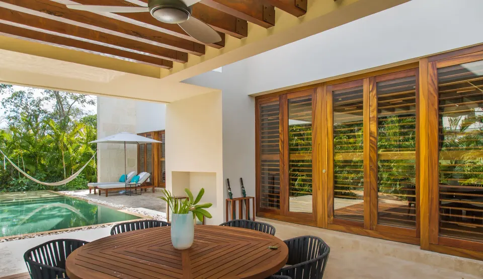 Outdoor dining patio with round table and view of private pool at Chablé Yucatán