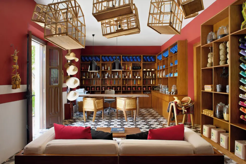 Bright boutique shop with wooden shelving and birdcage lights at Chablé Yucatán