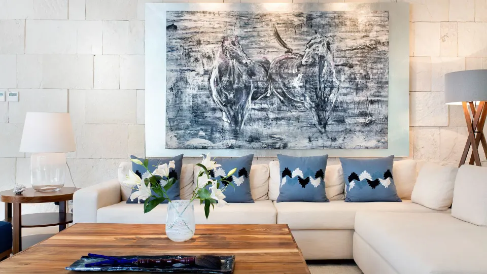 Close-up of corner sofa and monochrome artwork in suite at Chablé Yucatán