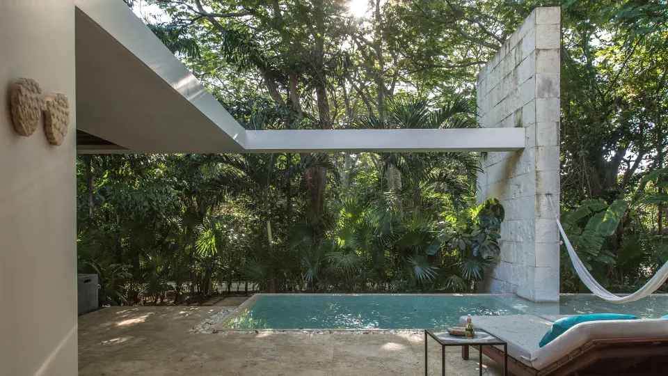 Shaded private pool with hammock and jungle foliage at Chablé Yucatán