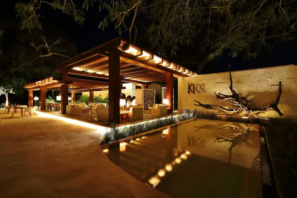 Open-air nighttime bar pavilion with reflecting pool at Chablé Yucatán