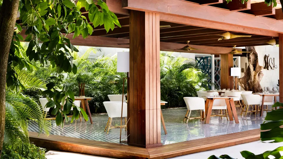 Open-air dining terrace under wooden pergola at Chablé Yucatán