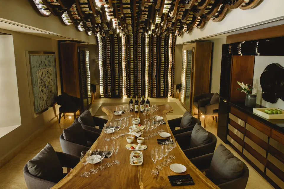 Private dining table set for a tasting beneath a sculptural wooden ceiling at Chablé Yucatán.