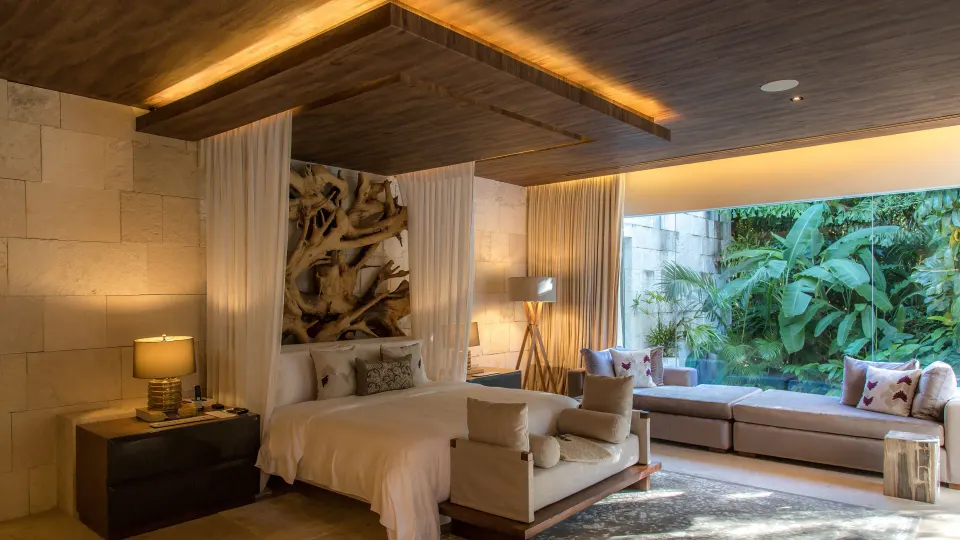 Royal Villa bedroom with sofa daybed and garden view at Chablé Yucatán