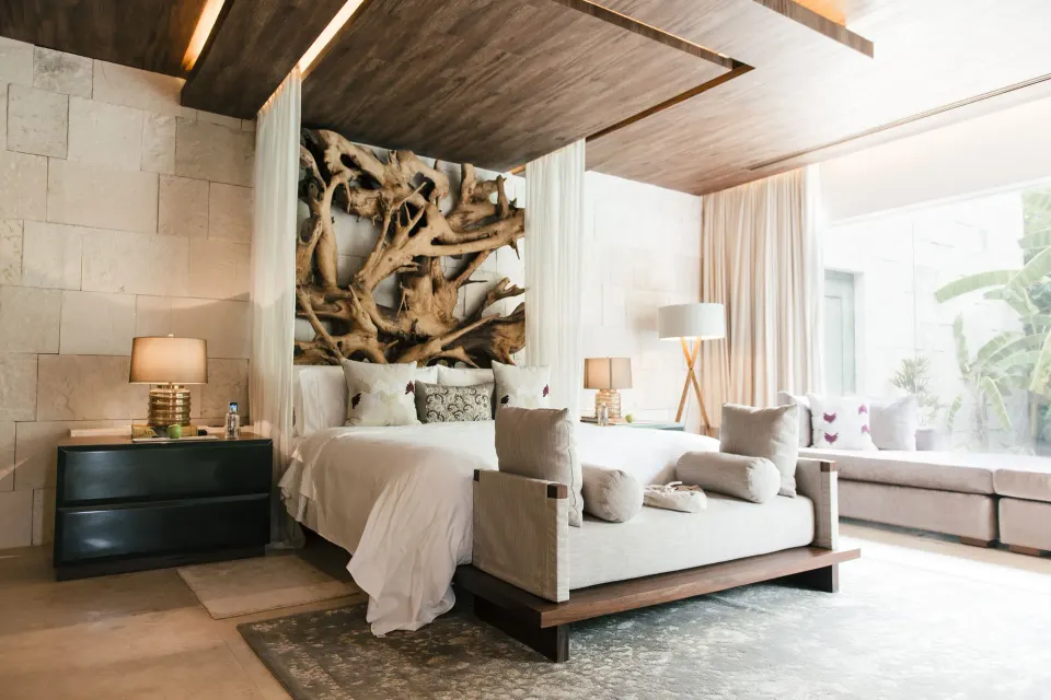 Royal Villa bedroom with carved wood headboard and daybed at Chablé Yucatán