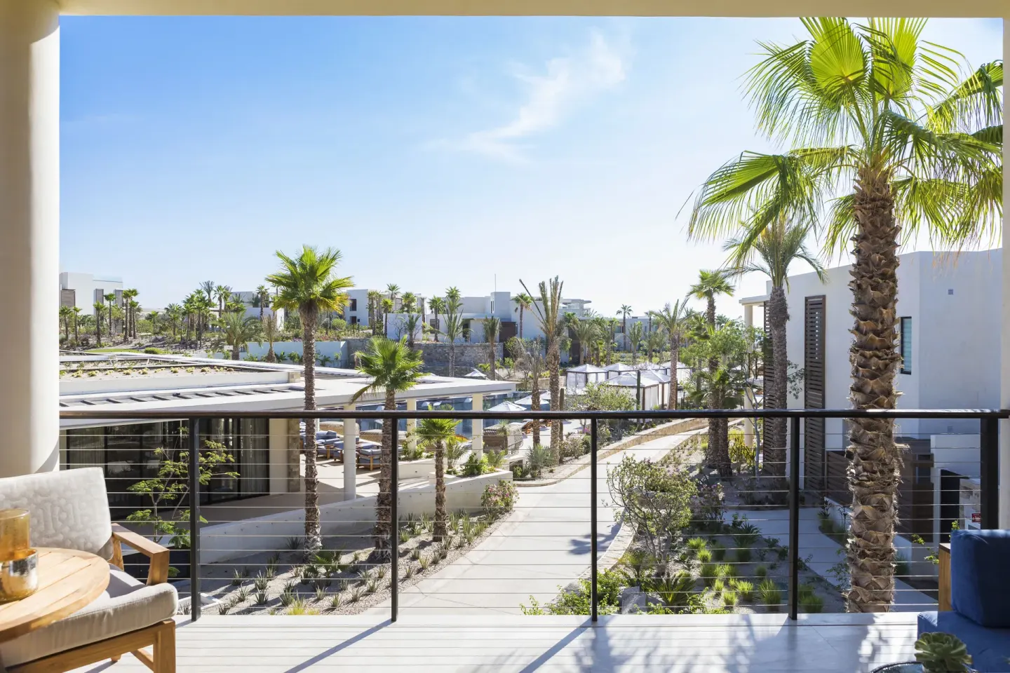 Balcony view over palms and resort pathways at Chileno Bay Resort & Residences.
