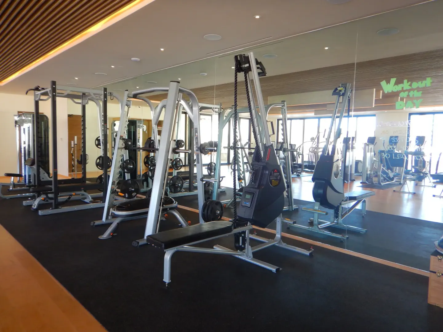 Strength-training machines and mirrored walls in the gym at Chileno Bay Resort & Residences.