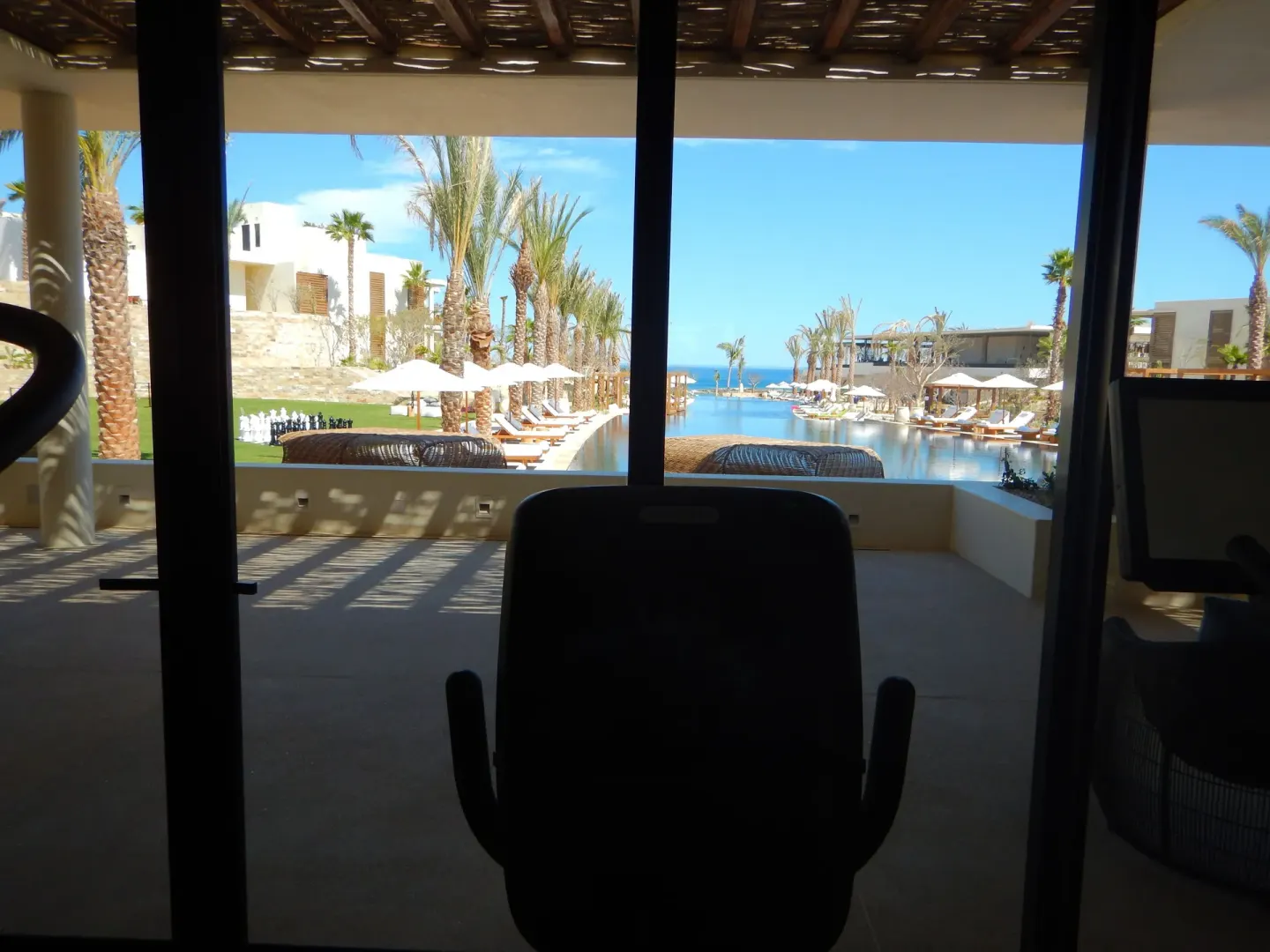 Fitness equipment facing the resort pool and ocean at Chileno Bay Resort & Residences.