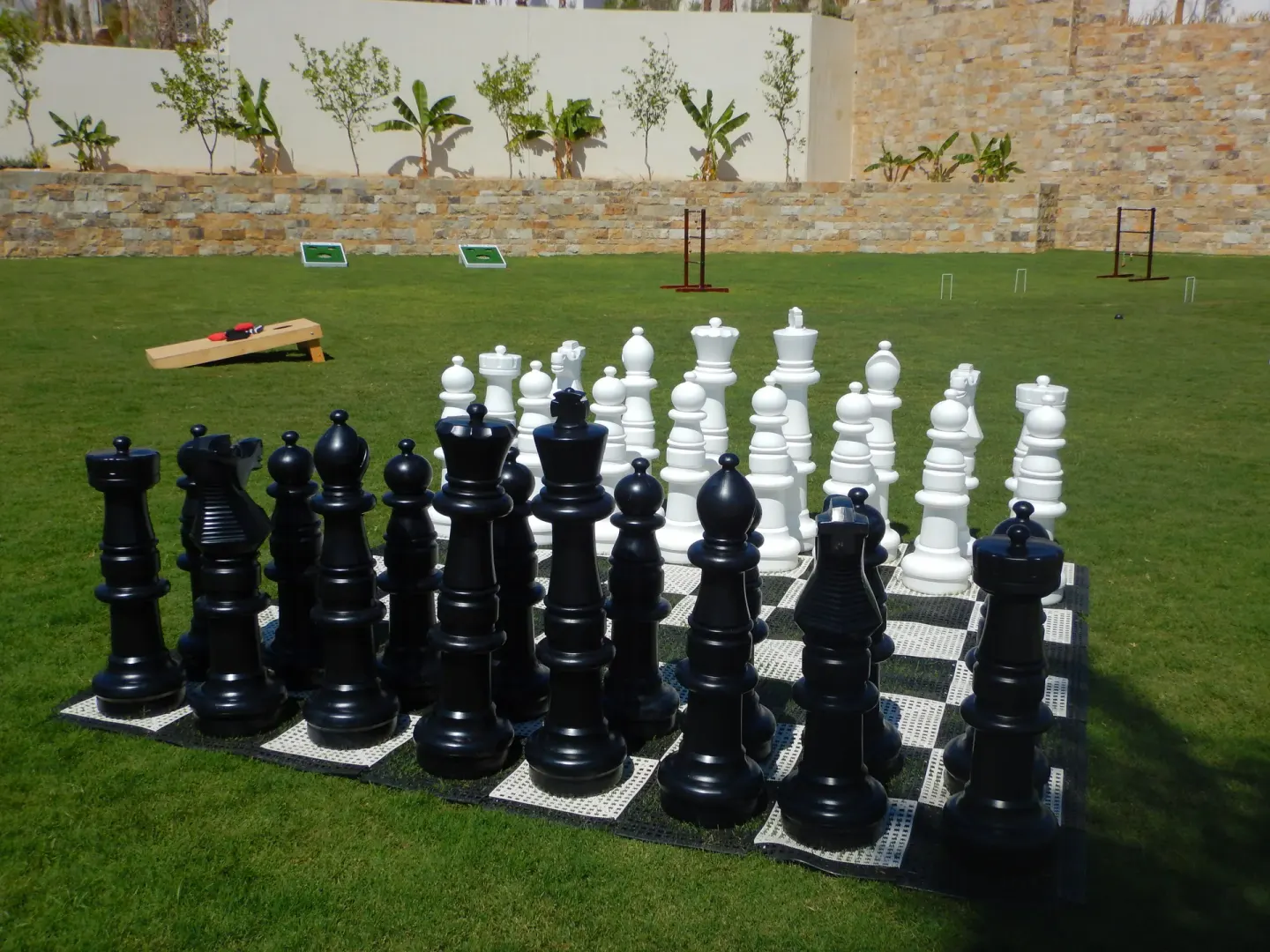 Giant chess pieces stand on a lawn at Chileno Bay Resort & Residences.