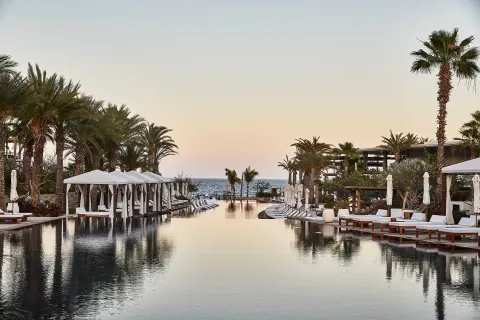 Long infinity-style pool leading toward the ocean at Chileno Bay Resort & Residences.
