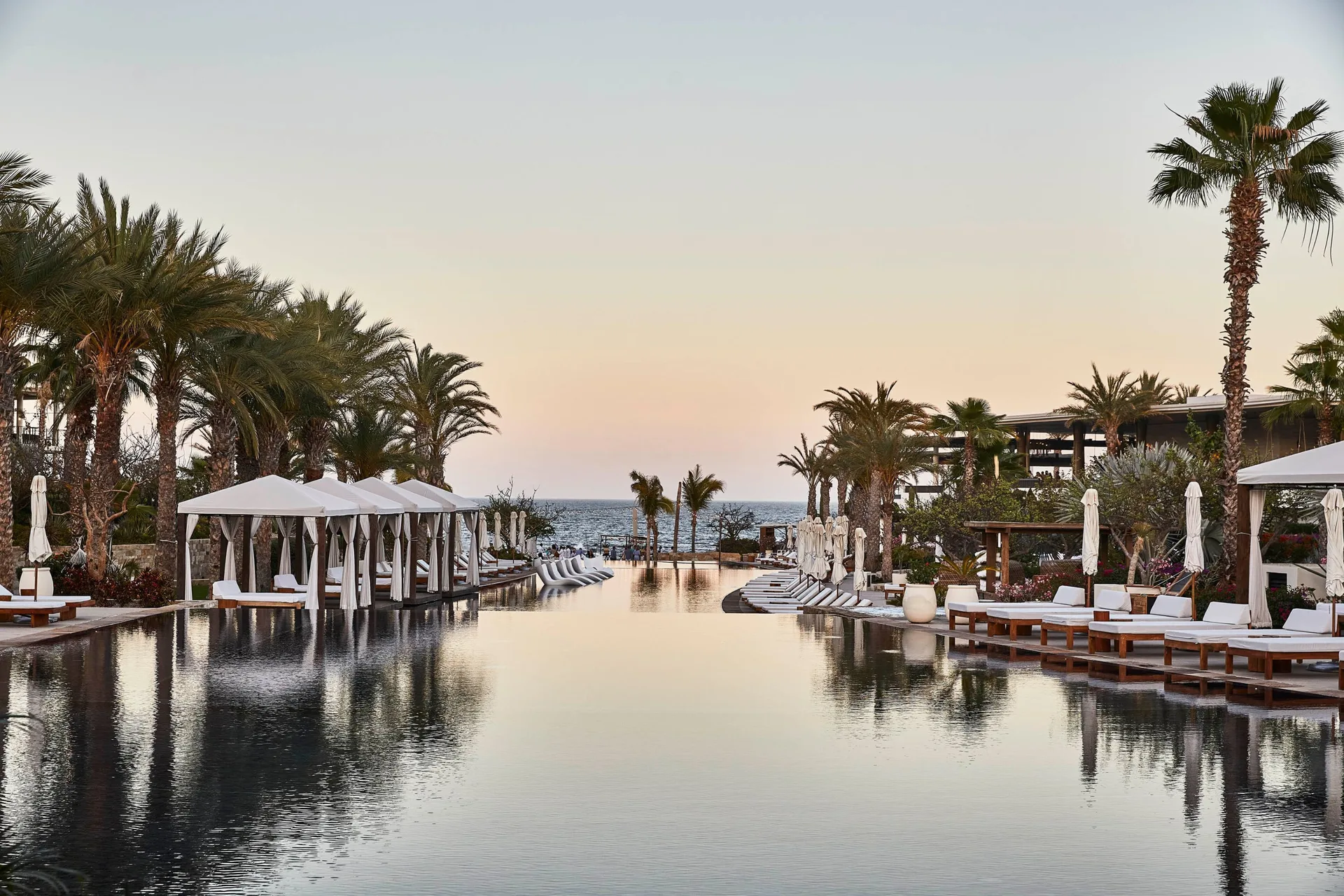 Long infinity-style pool leading toward the ocean at Chileno Bay Resort & Residences.
