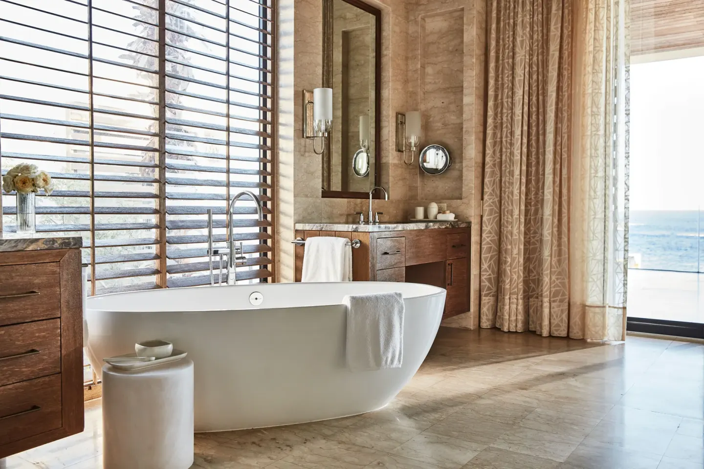 Freestanding bathtub in an ocean-view bathroom at Chileno Bay Resort & Residences.