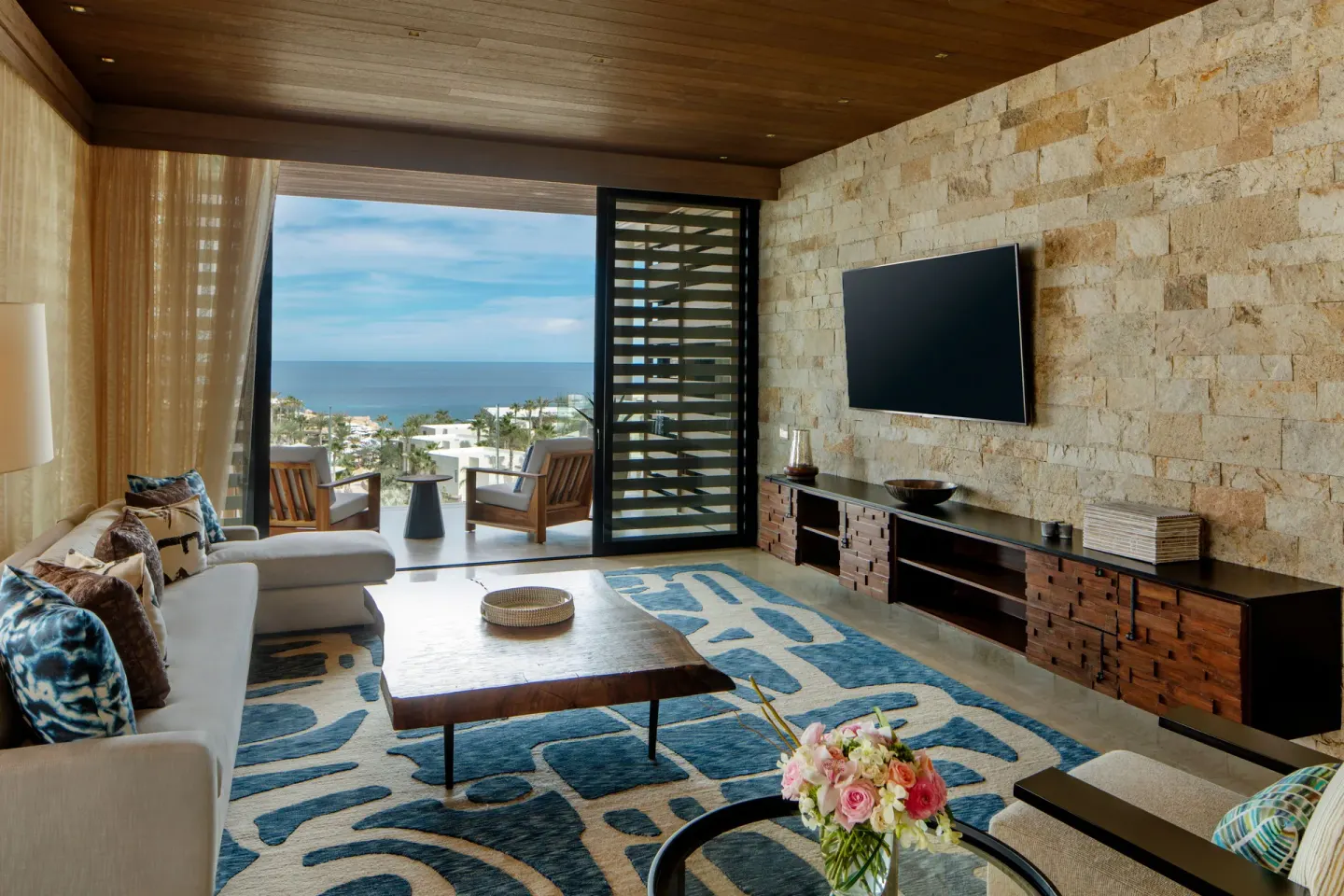 Living room with terrace and ocean view at Chileno Bay Resort & Residences.