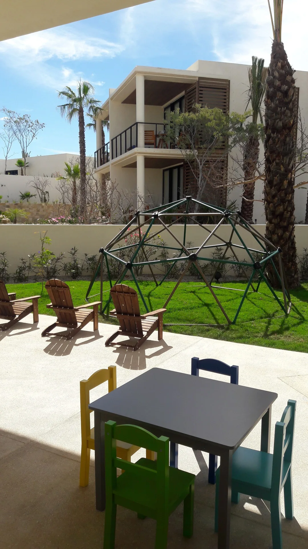 Outdoor children's play area with climbing dome at Chileno Bay Resort & Residences.