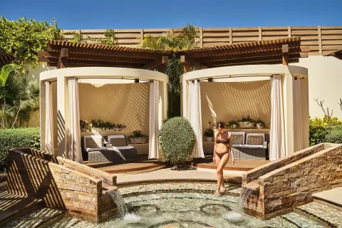 Private cabanas and a bubbling water feature at Chileno Bay Resort & Residences.