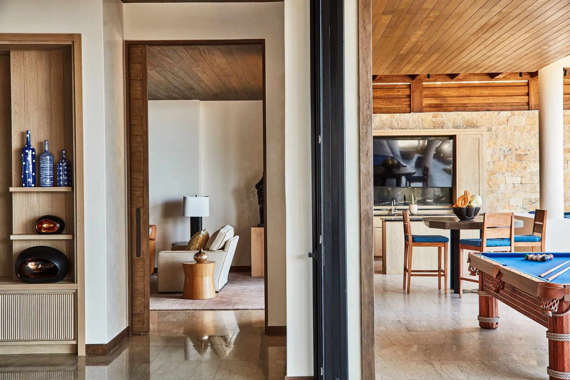 Indoor-outdoor game and bar area in a residence at Chileno Bay Resort & Residences.