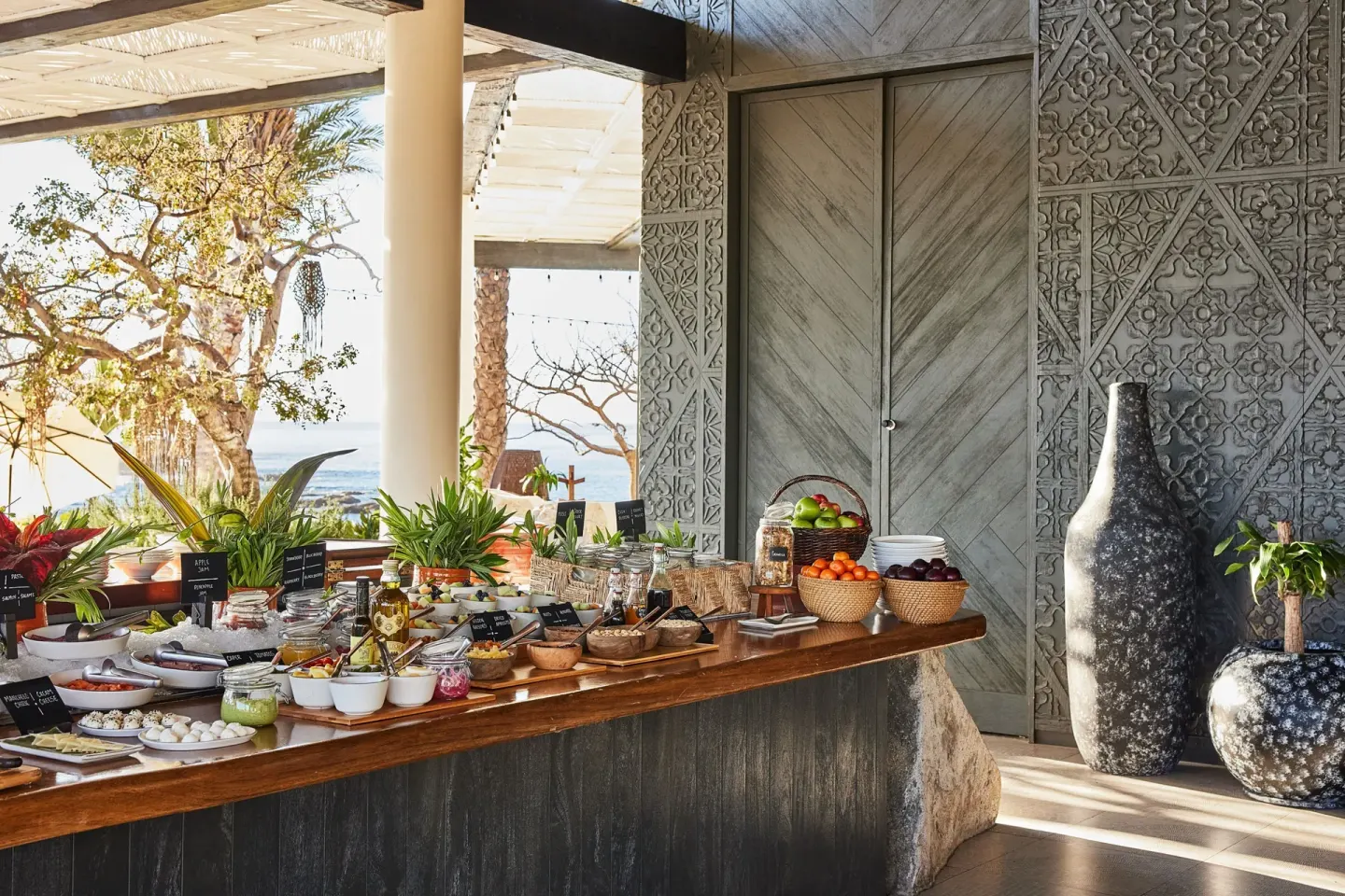 Buffet display with fruit, jars, and condiments at Chileno Bay Resort & Residences.