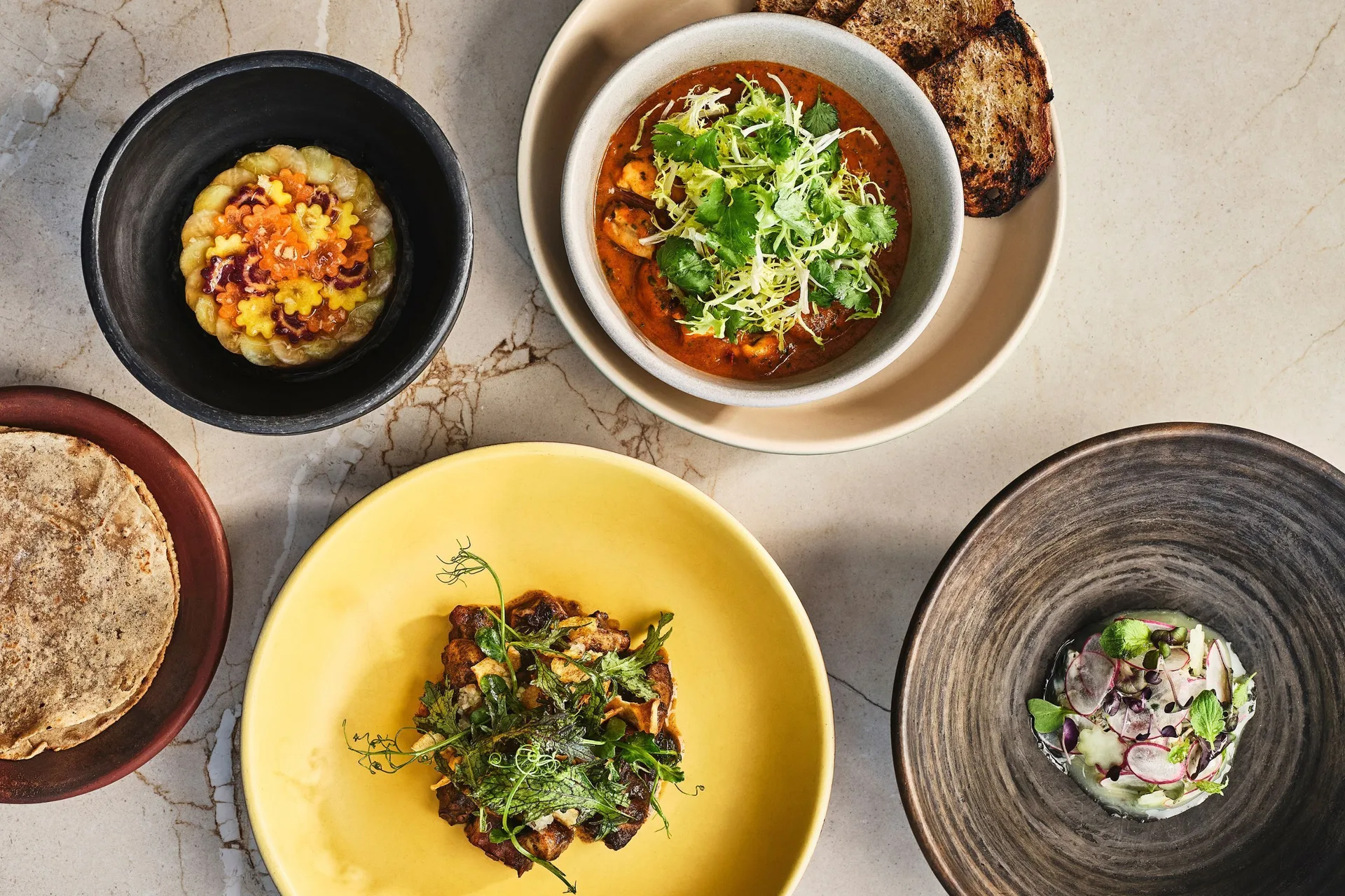 Overhead view of plated Mexican dishes at Chileno Bay Resort & Residences.