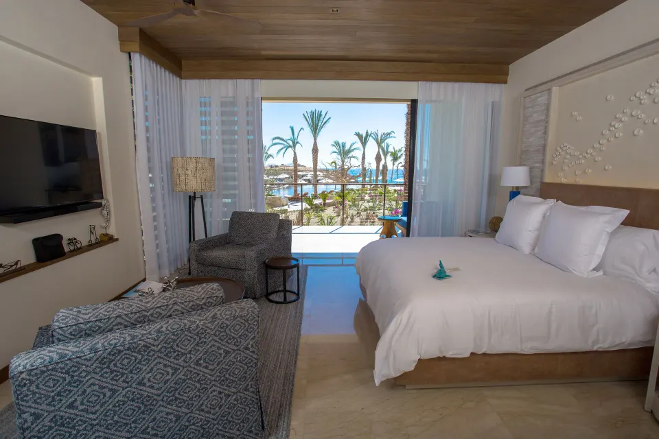 Resort-view guest room with king bed and balcony at Chileno Bay Resort & Residences.