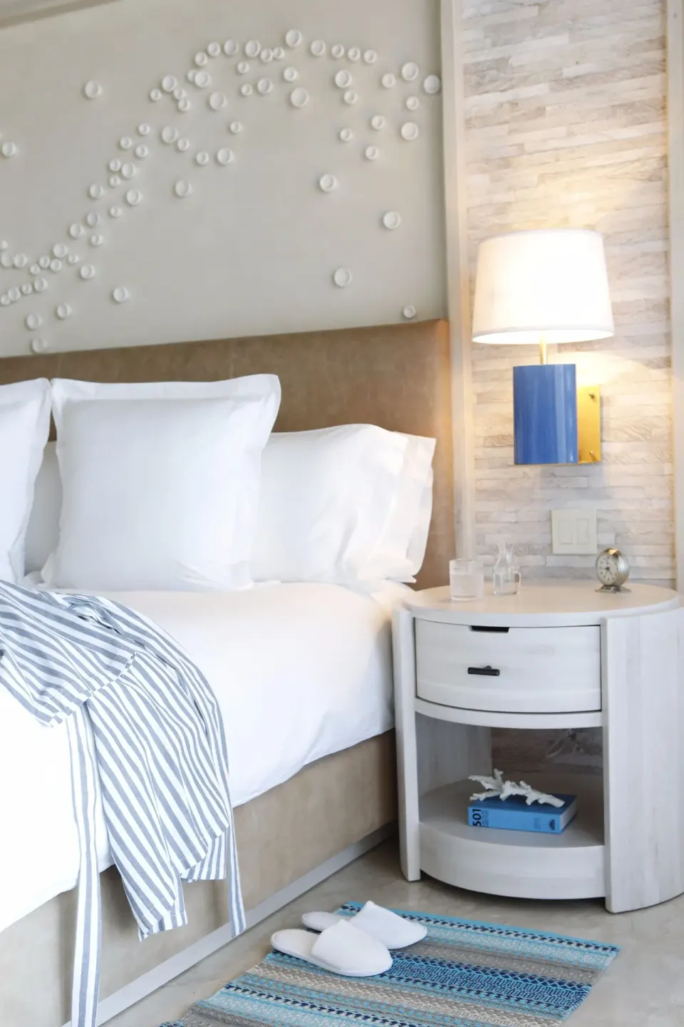 Close-up of a king bed and bedside table at Chileno Bay Resort & Residences.