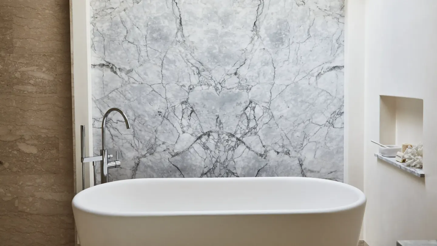 Freestanding bathtub in a Signature Villa bathroom at Chileno Bay Resort & Residences with marble wall.