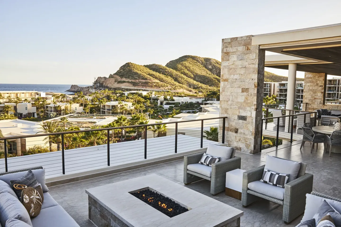 Outdoor lounge terrace of a Signature Villa at Chileno Bay Resort & Residences overlooking hillside and sea.