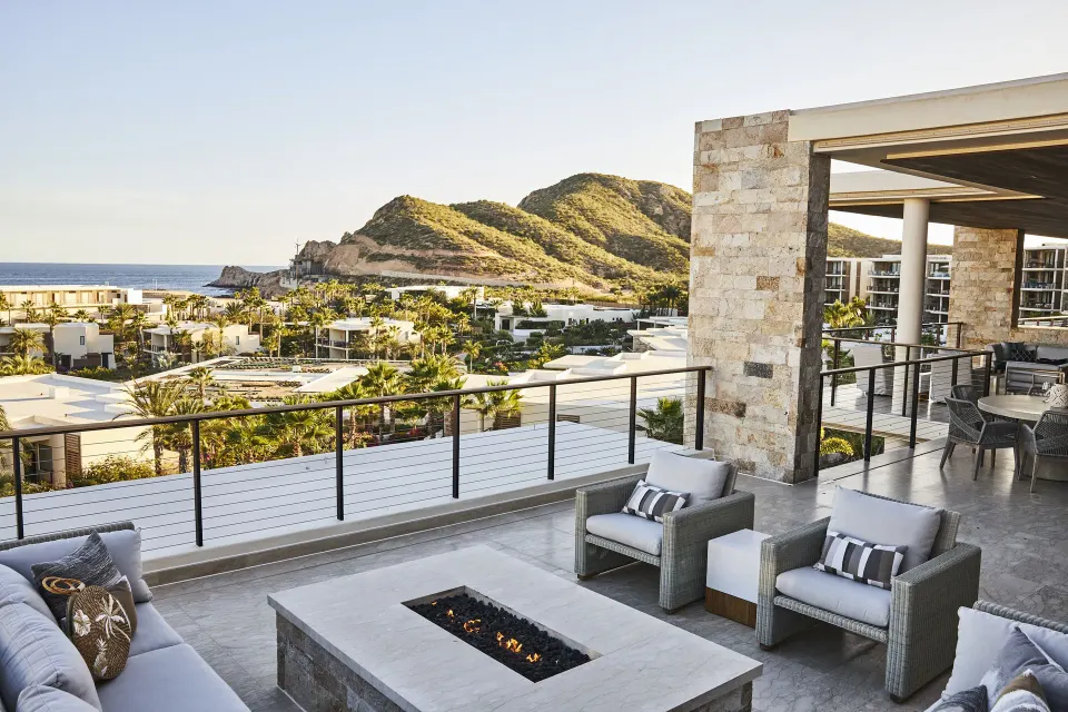 Outdoor lounge terrace of a Signature Villa at Chileno Bay Resort & Residences overlooking hillside and sea.