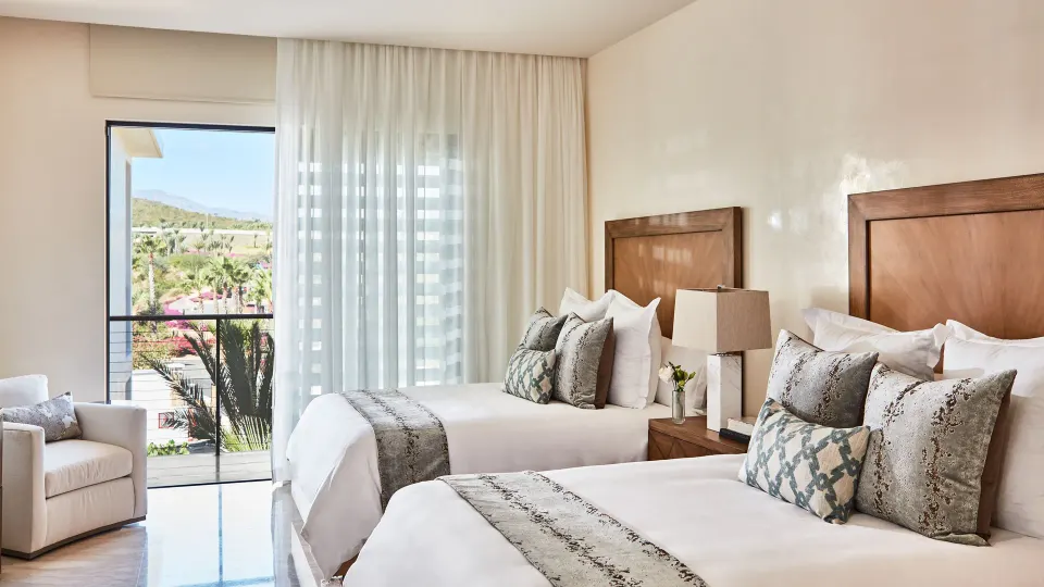 Double-bed room with balcony in the Signature Villa at Chileno Bay Resort & Residences.