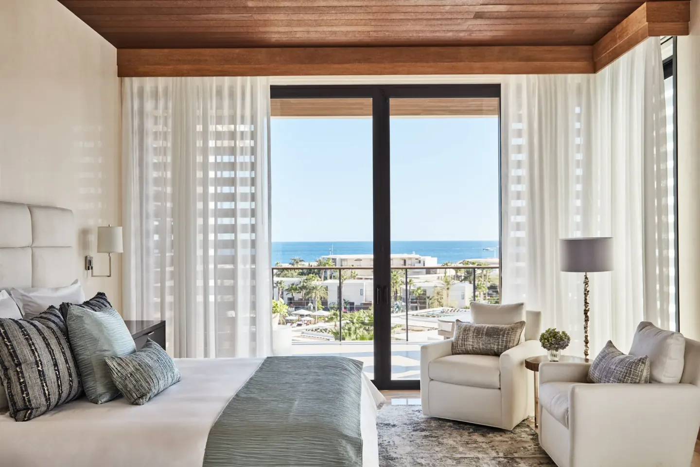 King bedroom with ocean-facing balcony at Chileno Bay Resort & Residences.