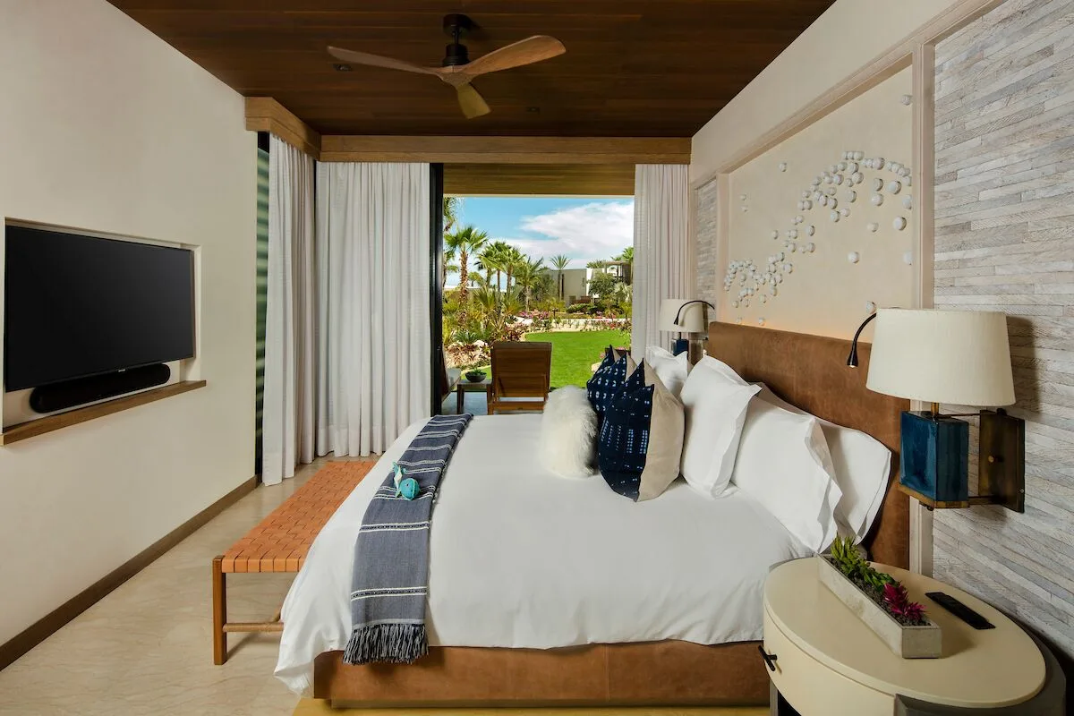 Garden View suite bedroom with king bed and patio at Chileno Bay Resort & Residences.