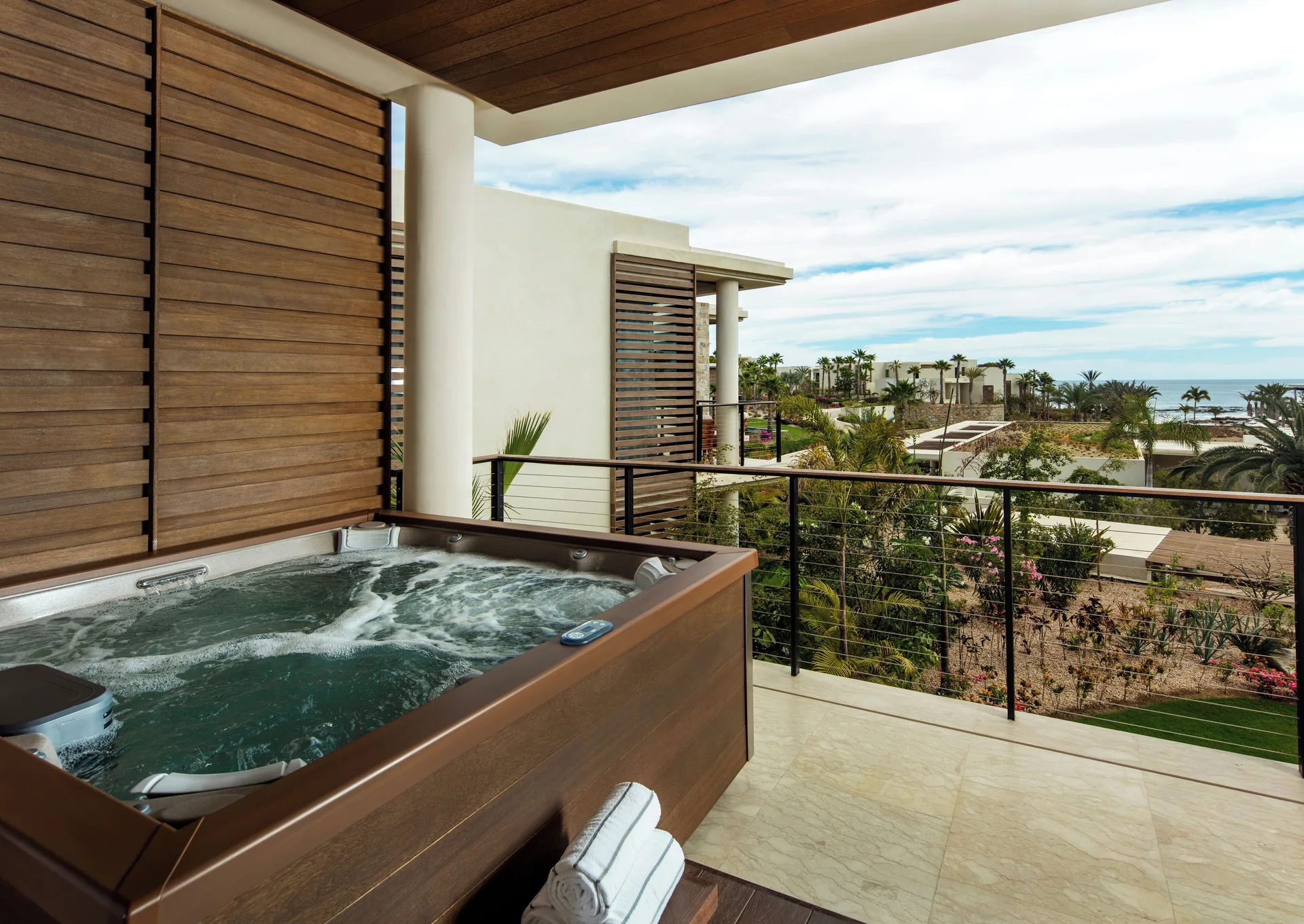 Balcony hot tub with garden and ocean view at Chileno Bay Resort & Residences.