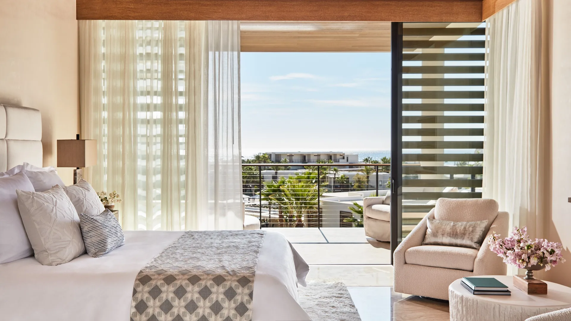 King bedroom with balcony view in a 3-bedroom villa at Chileno Bay Resort & Residences.