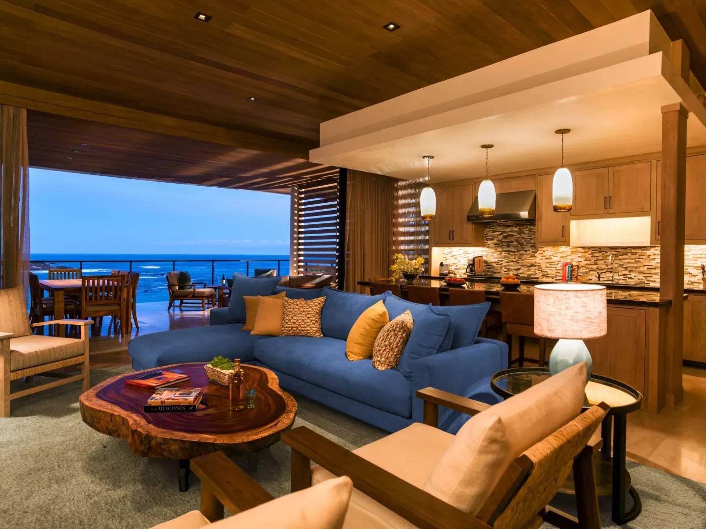 Oceanfront villa living room with kitchen and terrace at Chileno Bay Resort & Residences.