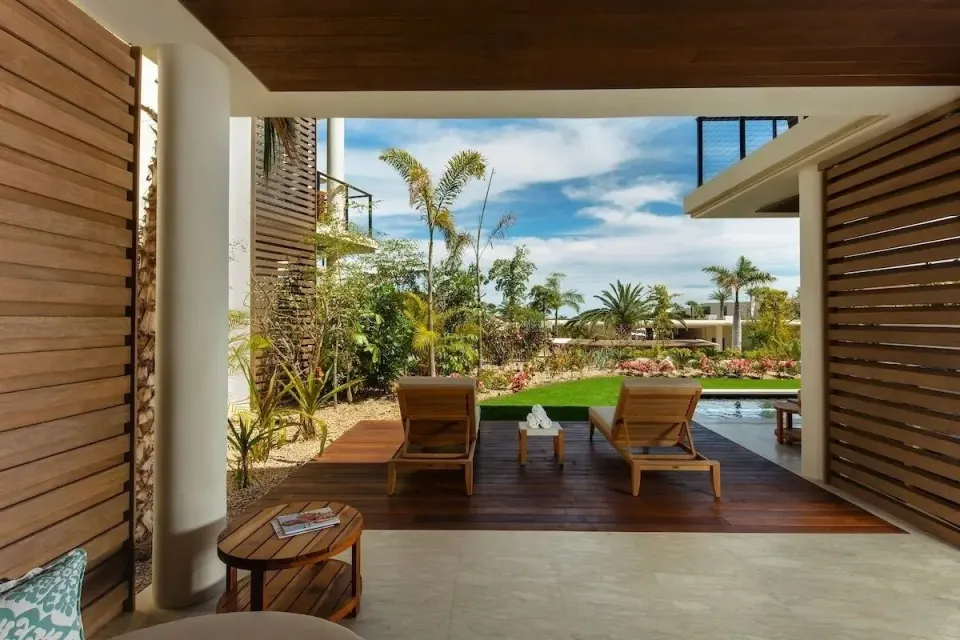 Villa pool deck with lounge chairs and garden view at Chileno Bay Resort & Residences.