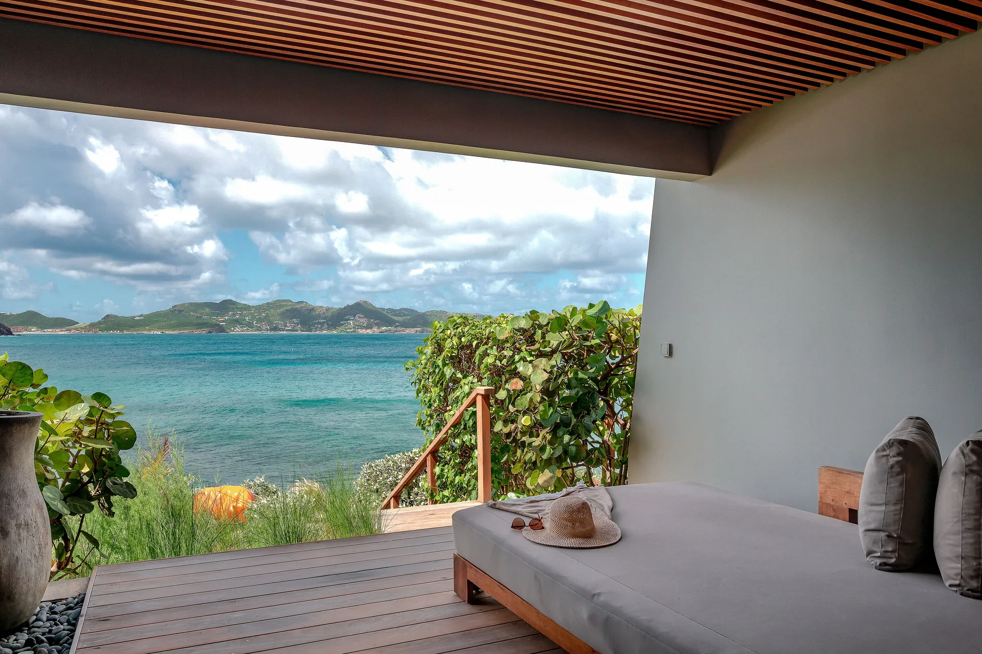 Covered daybed terrace with ocean and island views at Christopher Hotel.