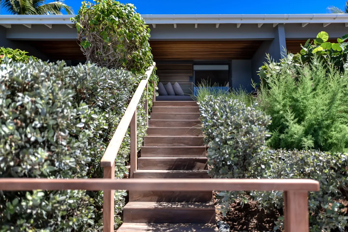 Garden stairway leading to a shaded guest terrace at Christopher Hotel.