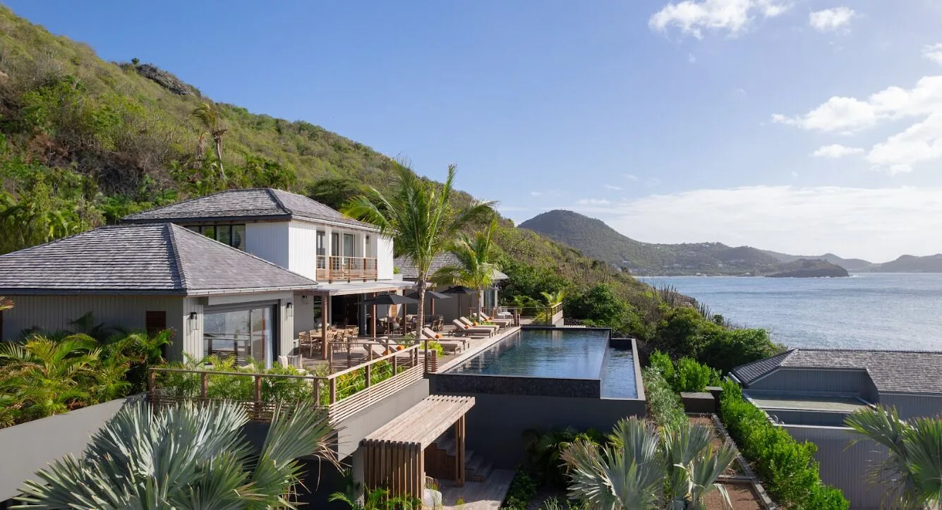 Hillside resort buildings with pool and sea views at Christopher Hotel.