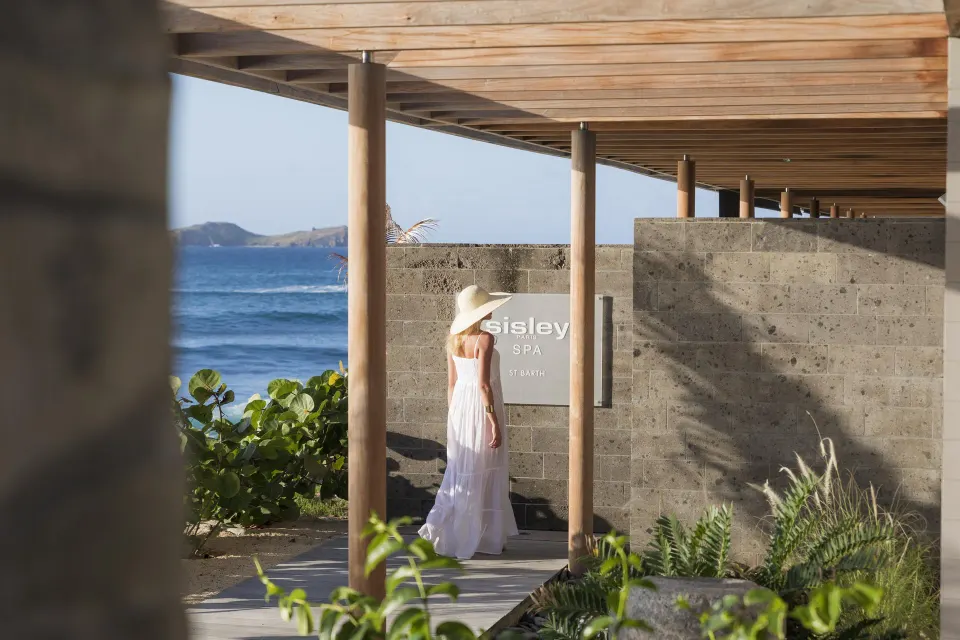 A covered seaside walkway leads past the spa entrance at Christopher Hotel.