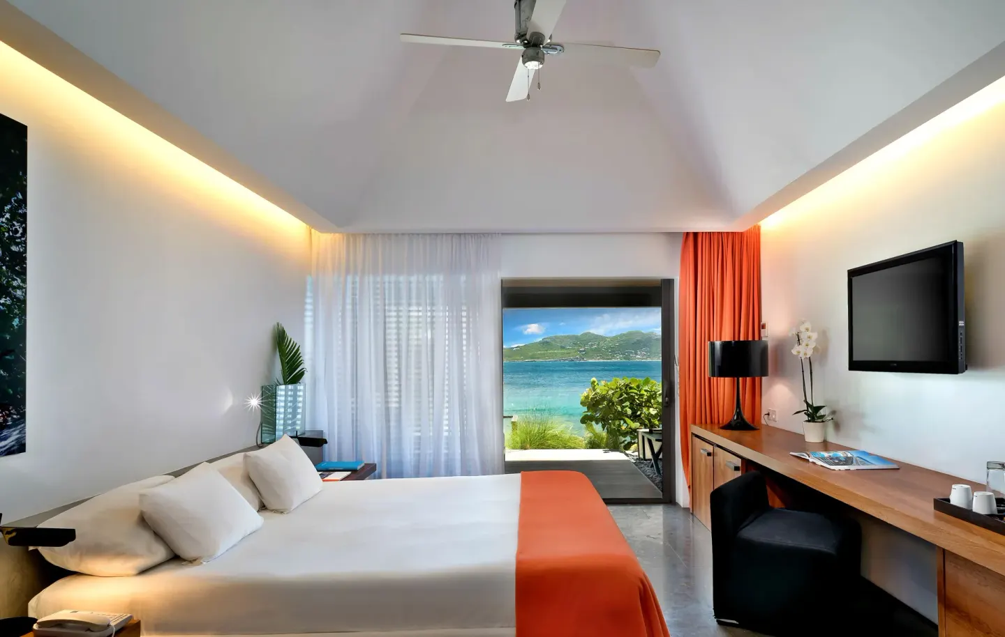 King bed guest room with vaulted ceiling and sea view at Christopher Hotel.