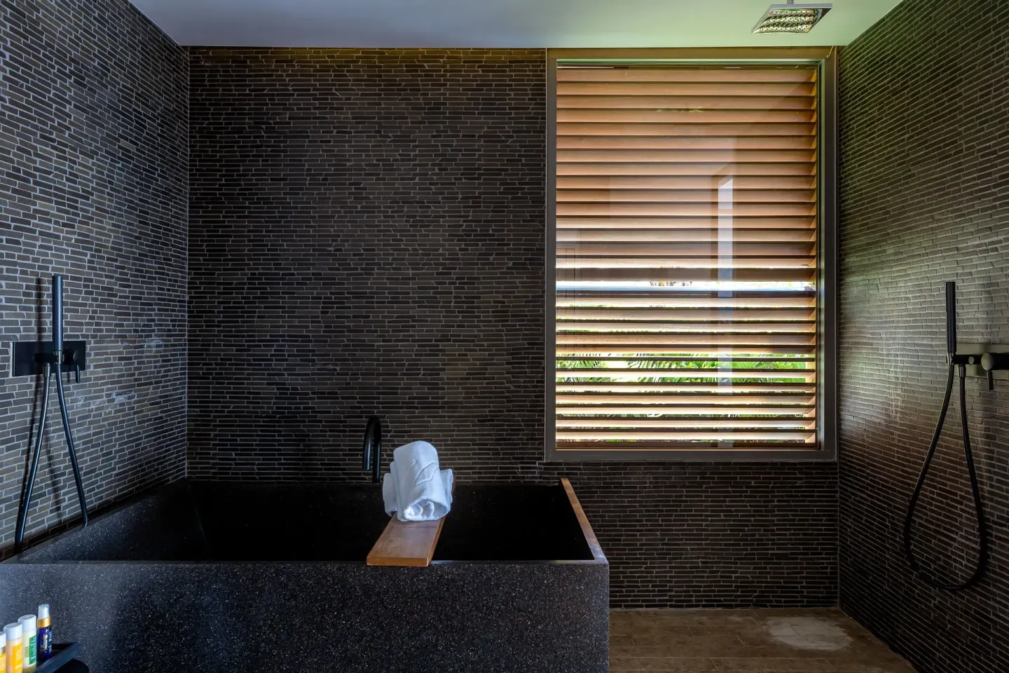 Panoramic Suite bathroom with black soaking tub at Christopher Hotel.