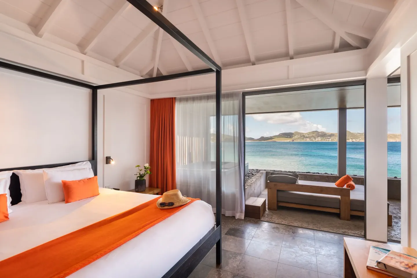 Panoramic Suite king bed and terrace with ocean view at Christopher Hotel.