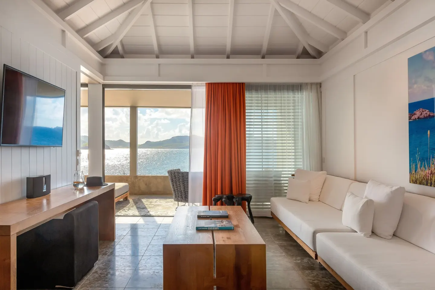 Panoramic Suite living area with sofa and ocean-facing windows at Christopher Hotel.