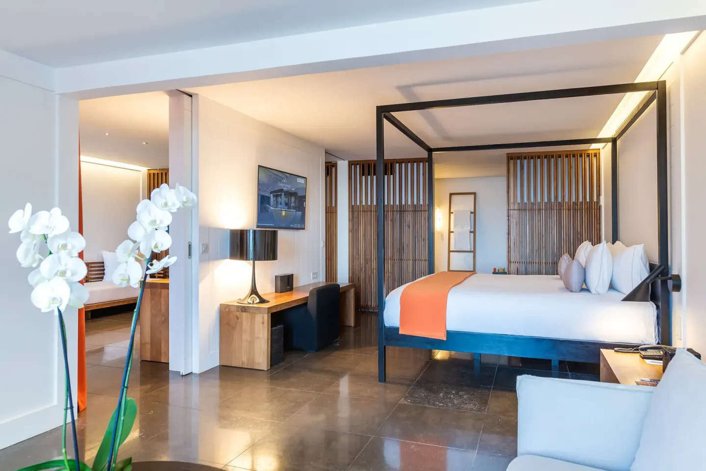 Ocean Spa Suite bedroom with canopy bed and desk at Christopher Hotel.