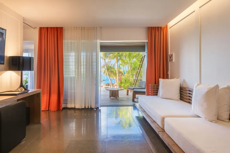 Ocean Spa Suite lounge with daybed opening to a palm-framed terrace at Christopher Hotel.
