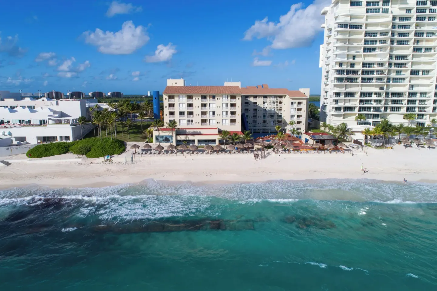 Wide aerial view of Club Regina Cancun facing the beach and turquoise water.