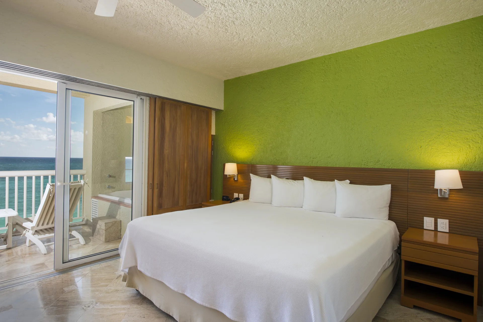 Classic Studio king bed and balcony with ocean view at Club Regina Cancun.