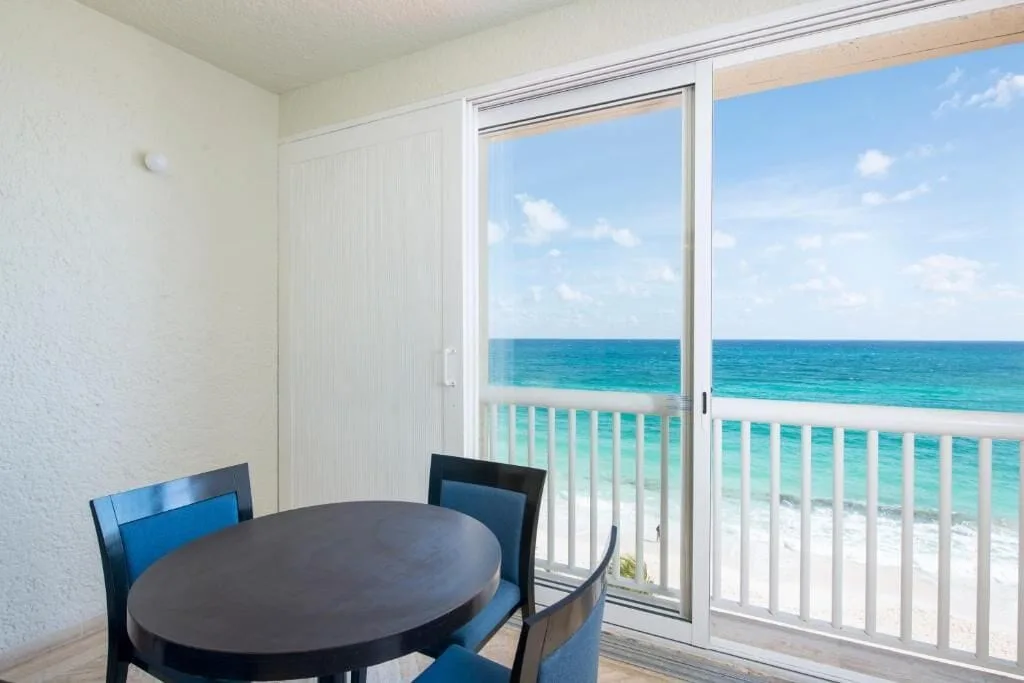 Deluxe suite dining area and balcony ocean view at Club Regina Cancun.