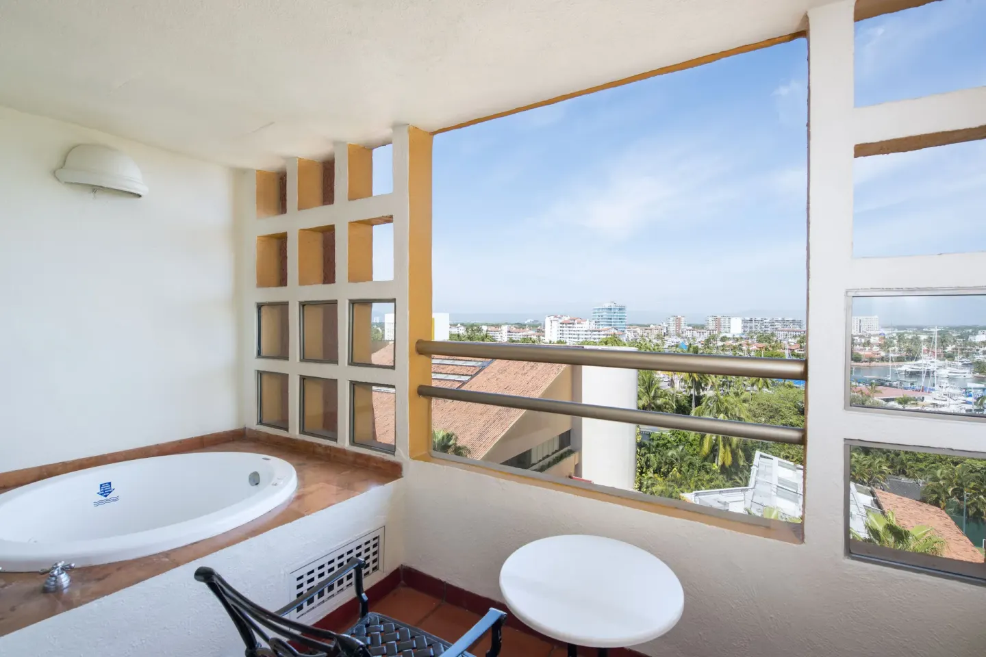 Balcony with soaking tub and city view at Club Regina Puerto Vallarta.