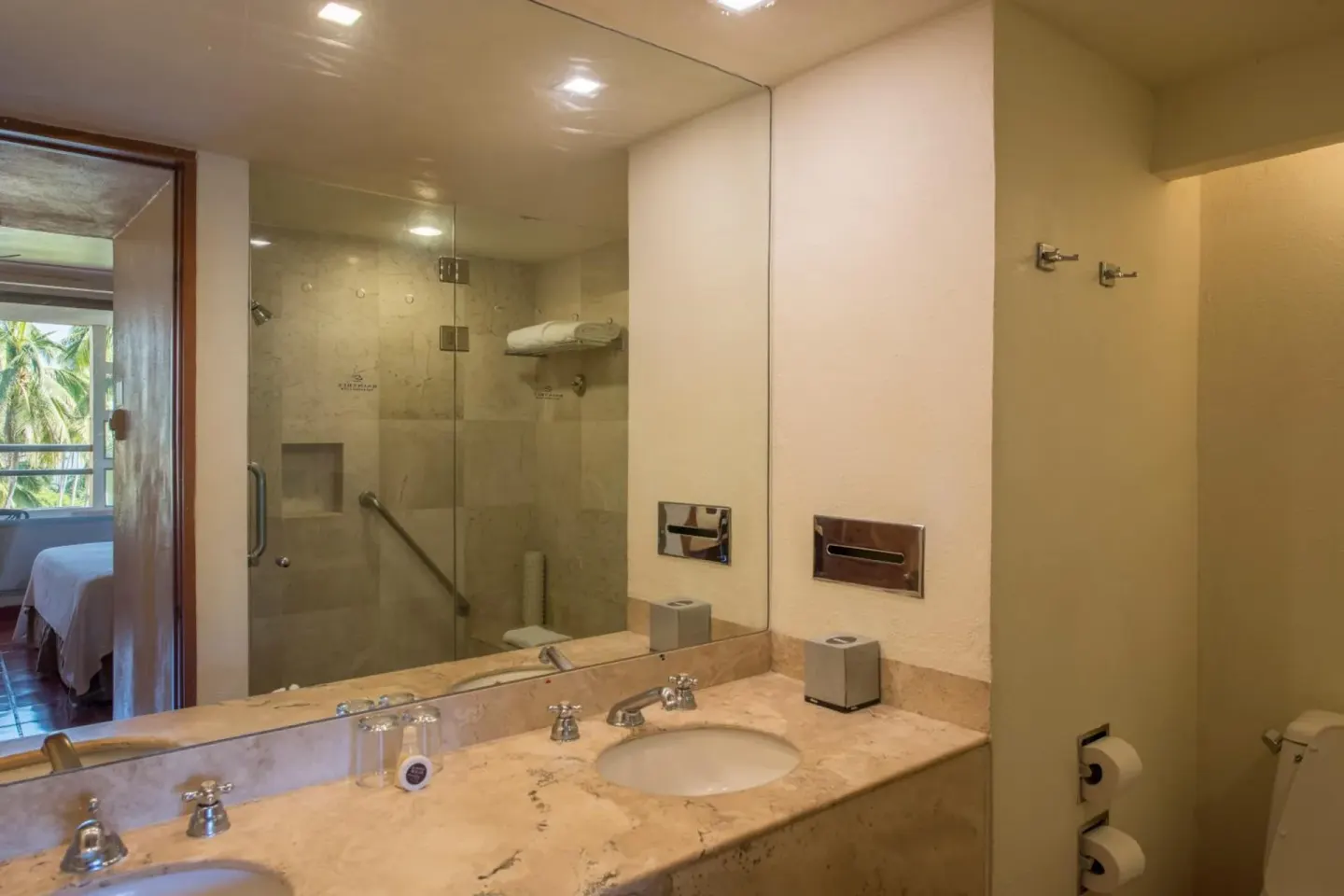 Guest bathroom vanity and glass shower at Club Regina Puerto Vallarta.